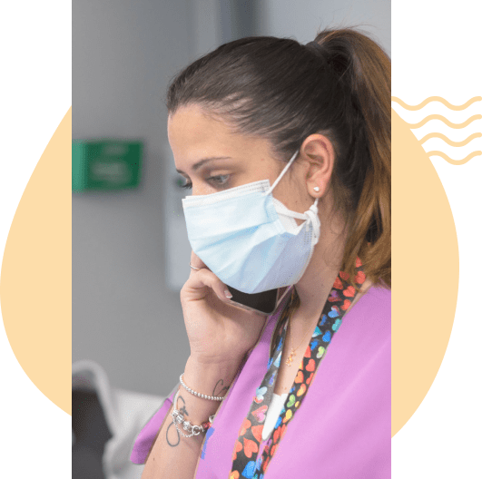 Nurse answering the phone with a mask